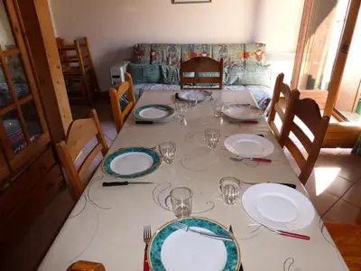 a table with plates and wine glasses on it at Résidence Les Jardins Alpins - Jardins Alpins B29 MAE-5209 in Saint-Gervais-les-Bains