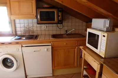 a kitchen with a microwave and a washer and a sink at Résidence Les Jardins Alpins - Jardins Alpins B29 MAE-5209 in Saint-Gervais-les-Bains
