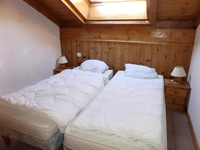 a bedroom with two beds and a skylight at Résidence Les Jardins Alpins - Jardins Alpins B29 MAE-5209 in Saint-Gervais-les-Bains