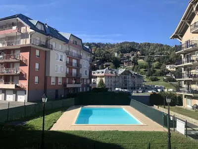 a swimming pool in front of some buildings at Résidence Le Grand Panorama - Grand Panorama 111 MAE-5213 in Saint-Gervais-les-Bains