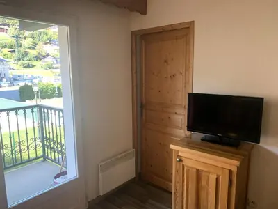 a living room with a flat screen tv next to a window at Résidence Le Grand Panorama - Grand Panorama 111 MAE-5213 in Saint-Gervais-les-Bains