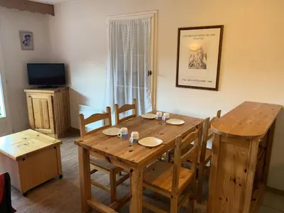 a dining room with a wooden table and chairs at Résidence Le Grand Panorama - Grand Panorama 303 MAE-5215 in Saint-Gervais-les-Bains