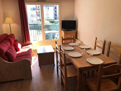 a living room with a wooden table and a couch at Résidence Le Grand Panorama - Grand Panorama 107 MAE-5232 in Saint-Gervais-les-Bains