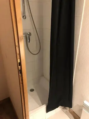 a shower with a black shower curtain in a bathroom at Résidence Le Grand Panorama - Grand Panorama 107 MAE-5232 in Saint-Gervais-les-Bains