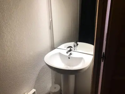 a white sink in a bathroom with a mirror at Résidence Le Grand Panorama - Grand Panorama 107 MAE-5232 in Saint-Gervais-les-Bains