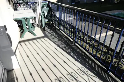 a bench sitting on a porch next to a fence at Résidence Le Grand Panorama - Grand Panorama 105 MAE-5237 in Saint-Gervais-les-Bains