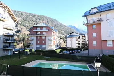 a swimming pool in the middle of some buildings at Résidence Le Grand Panorama - Grand Panorama 105 MAE-5237 in Saint-Gervais-les-Bains