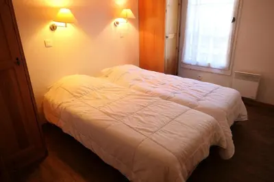 a white bed in a room with a window at Résidence Le Grand Panorama - Grand Panorama 105 MAE-5237 in Saint-Gervais-les-Bains