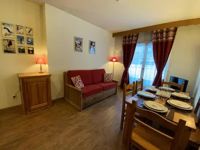 a living room with a red couch and a table at Résidence Le Grand Panorama - Grand Panorama 006 MAE-5249 in Saint-Gervais-les-Bains