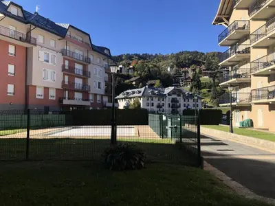 a fence in front of some apartment buildings at Résidence Le Grand Panorama - Grand Panorama 006 MAE-5249 in Saint-Gervais-les-Bains