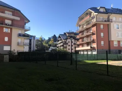 a fence in front of some apartment buildings at Résidence Le Grand Panorama - Grand Panorama 006 MAE-5249 in Saint-Gervais-les-Bains