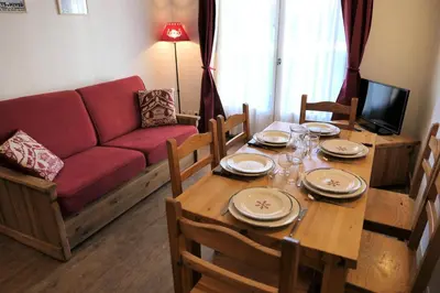 a living room with a table and a couch at Résidence Le Grand Panorama - Grand Panorama 006 MAE-5249 in Saint-Gervais-les-Bains