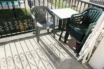 two chairs and a table on a balcony with a fence at Résidence Le Grand Panorama - Grand Panorama 110 MAE-5251 in Saint-Gervais-les-Bains