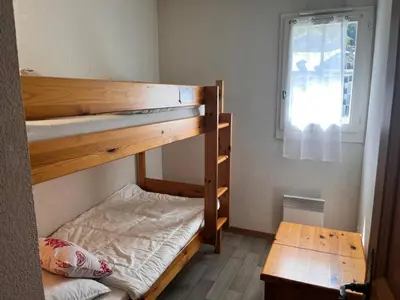 a bedroom with two bunk beds and a window at Résidence Le Grand Panorama - Grand Panorama 104 MAE-5255 in Saint-Gervais-les-Bains