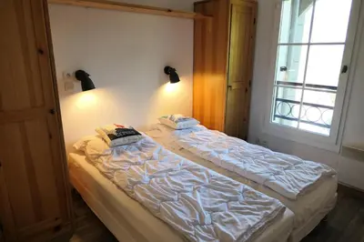 a bed sitting in a room with a window at Résidence Le Grand Panorama - Grand Panorama 416 MAE-5261 in Saint-Gervais-les-Bains