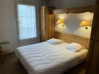 a large white bed in a bedroom with a window at Résidence Le Grand Panorama - Grand Panorama 401 MAE-5268 in Saint-Gervais-les-Bains