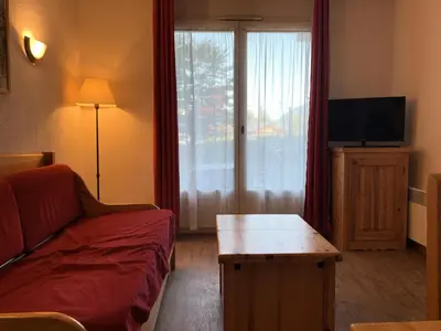 a living room with a couch and a table and a window at Résidence Le Grand Panorama - Grand Panorama 001 MAE-5280 in Saint-Gervais-les-Bains
