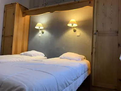two beds in a room with two lamps on the wall at Résidence Le Grand Panorama - Grand Panorama 001 MAE-5280 in Saint-Gervais-les-Bains