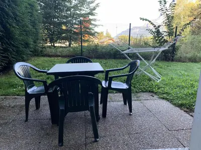 two chairs and a table with a table and a swing at Résidence Le Grand Panorama - Grand Panorama 001 MAE-5280 in Saint-Gervais-les-Bains