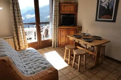 a living room with a table and chairs and a television at Résidence Les Aiguilles - Bat Vorassay - Vorassay C35 MAE-5282 in Saint-Gervais-les-Bains