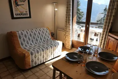 a living room with a table and a couch and a table and chairs at Résidence Les Aiguilles - Bat Vorassay - Vorassay C35 MAE-5282 in Saint-Gervais-les-Bains
