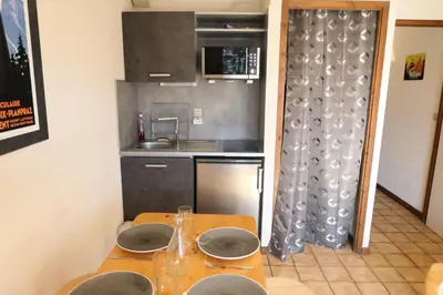 a small kitchen with a table with plates on it at Résidence Les Aiguilles - Bat Vorassay - Vorassay C35 MAE-5282 in Saint-Gervais-les-Bains