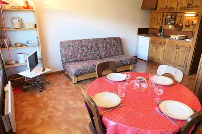 a living room with a red table and a couch at Résidence La Gelinotte - Gélinotte 6 MAE-5292 in Saint-Gervais-les-Bains