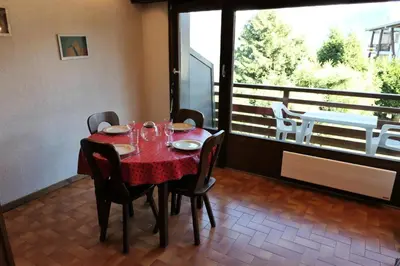 a dining room with a table and chairs and a balcony at Résidence La Gelinotte - Gélinotte 6 MAE-5292 in Saint-Gervais-les-Bains