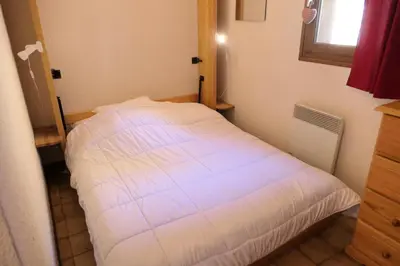 a white bed in a small room with a window at Résidence Les Aiguilles - Bat Vorassay - Vorassay C32 MAE-5293 in Saint-Gervais-les-Bains