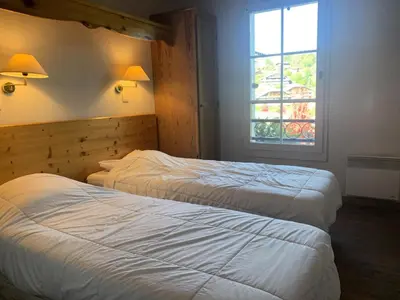 two beds in a hotel room with a window at Résidence Le Grand Panorama - Grand Panorama 202 MAE-5294 in Saint-Gervais-les-Bains