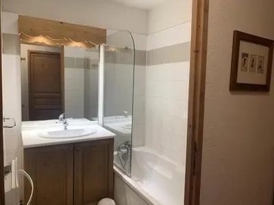 a bathroom with a sink and a tub and a mirror at Résidence Le Grand Panorama - Grand Panorama 202 MAE-5294 in Saint-Gervais-les-Bains