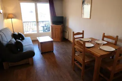 a living room with a table and a couch at Résidence Le Grand Panorama - Grand Panorama 102 MAE-5295 in Saint-Gervais-les-Bains