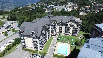 an aerial view of a large apartment building with a pool at Résidence Le Grand Panorama - Grand Panorama 102 MAE-5295 in Saint-Gervais-les-Bains
