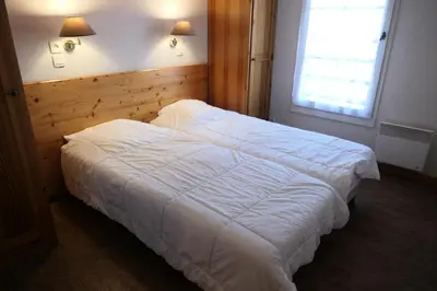 a bedroom with a white bed and a window at Résidence Le Grand Panorama - Grand Panorama 102 MAE-5295 in Saint-Gervais-les-Bains