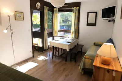 a living room with a table and a desk at Résidence Castel Des Roches C - Castel des Roches R5B MAE-5296 in Saint-Gervais-les-Bains