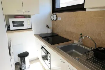a small kitchen with a sink and a microwave at Résidence Castel Des Roches C - Castel des Roches R5B MAE-5296 in Saint-Gervais-les-Bains