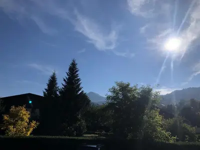 a view of the sun in the sky with trees at Résidence Castel Des Roches C - Castel des Roches R5B MAE-5296 in Saint-Gervais-les-Bains