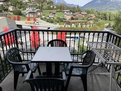 a table and chairs on a balcony with a view at Résidence Le Grand Panorama - Grand Panorama 402 MAE-5297 in Saint-Gervais-les-Bains