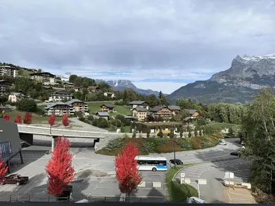 a bus parked in a parking lot with a mountain at Résidence Le Grand Panorama - Grand Panorama 402 MAE-5297 in Saint-Gervais-les-Bains