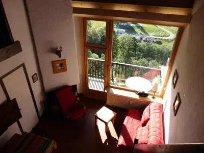 a living room with a couch and a large window at Résidence Bionnassay - Bionnassay B181 MAE-5332 in Les Contamines-Montjoie