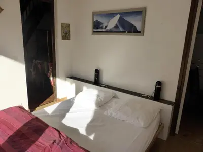 a bedroom with a bed and a picture on the wall at Résidence Bionnassay - Bionnassay B181 MAE-5332 in Les Contamines-Montjoie
