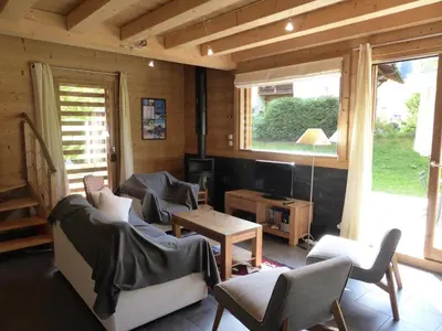 a living room with a couch and chairs and a tv at Chalet Champelet - Chalet Champelet MAE-5333 in Les Contamines-Montjoie