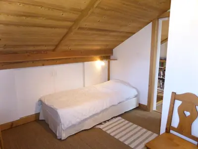 a bedroom with a bed and a wooden ceiling at Chalet Champelet - Chalet Champelet MAE-5333 in Les Contamines-Montjoie