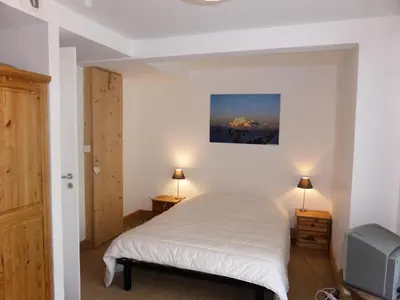 a bedroom with a bed and a tv in it at Chalet Champelet - Chalet Champelet MAE-5333 in Les Contamines-Montjoie