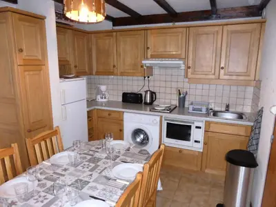 a kitchen with a table with chairs and a sink at Résidence Schuss - Schuss B230 MAE-5335 in Les Contamines-Montjoie