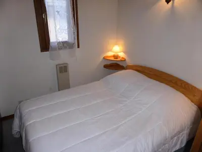 a bedroom with a white bed with a lamp on it at Résidence Schuss - Schuss B230 MAE-5335 in Les Contamines-Montjoie