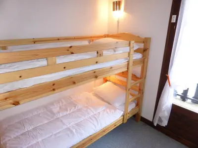 a bunk bed in a room with a wooden bunk bed at Résidence Schuss - Schuss B230 MAE-5335 in Les Contamines-Montjoie