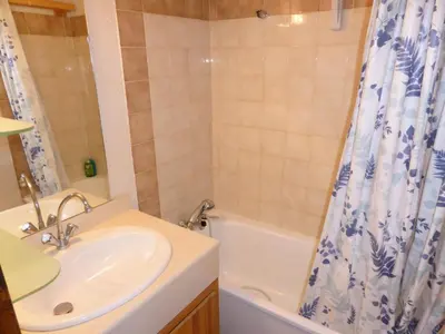 a bathroom with a sink and a shower curtain at Résidence Schuss - Schuss B230 MAE-5335 in Les Contamines-Montjoie