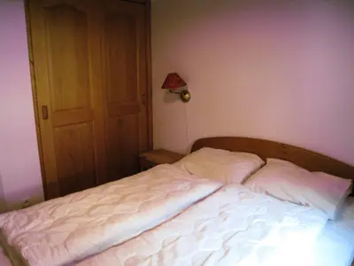 an unmade bed in a bedroom with a lamp at Résidence Floralie - Domaine Des Lapons 2 - Lapons 2 Floralie 6 MAE-5337 in Les Contamines-Montjoie