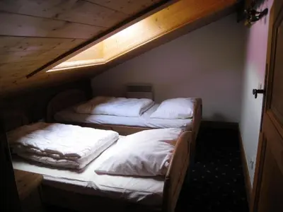 two twin beds in a room with an attic at Résidence Floralie - Domaine Des Lapons 2 - Lapons 2 Floralie 6 MAE-5337 in Les Contamines-Montjoie